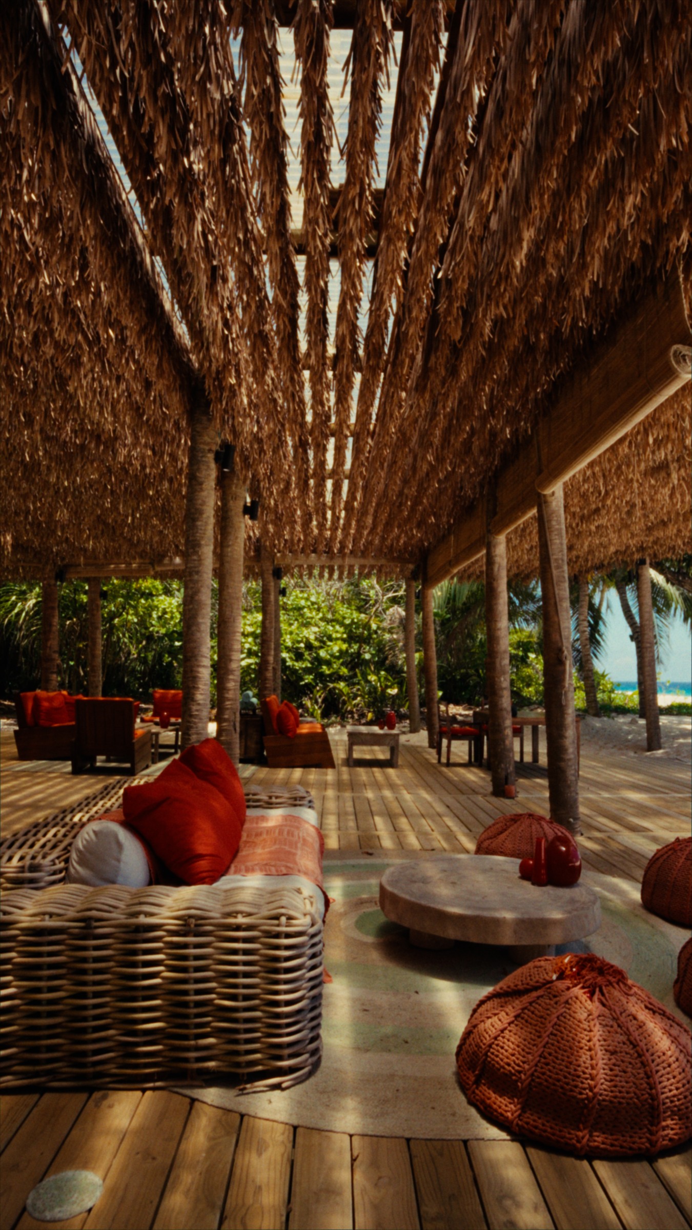 An open-air lounge, woven textures and a glimpse of the ocean.