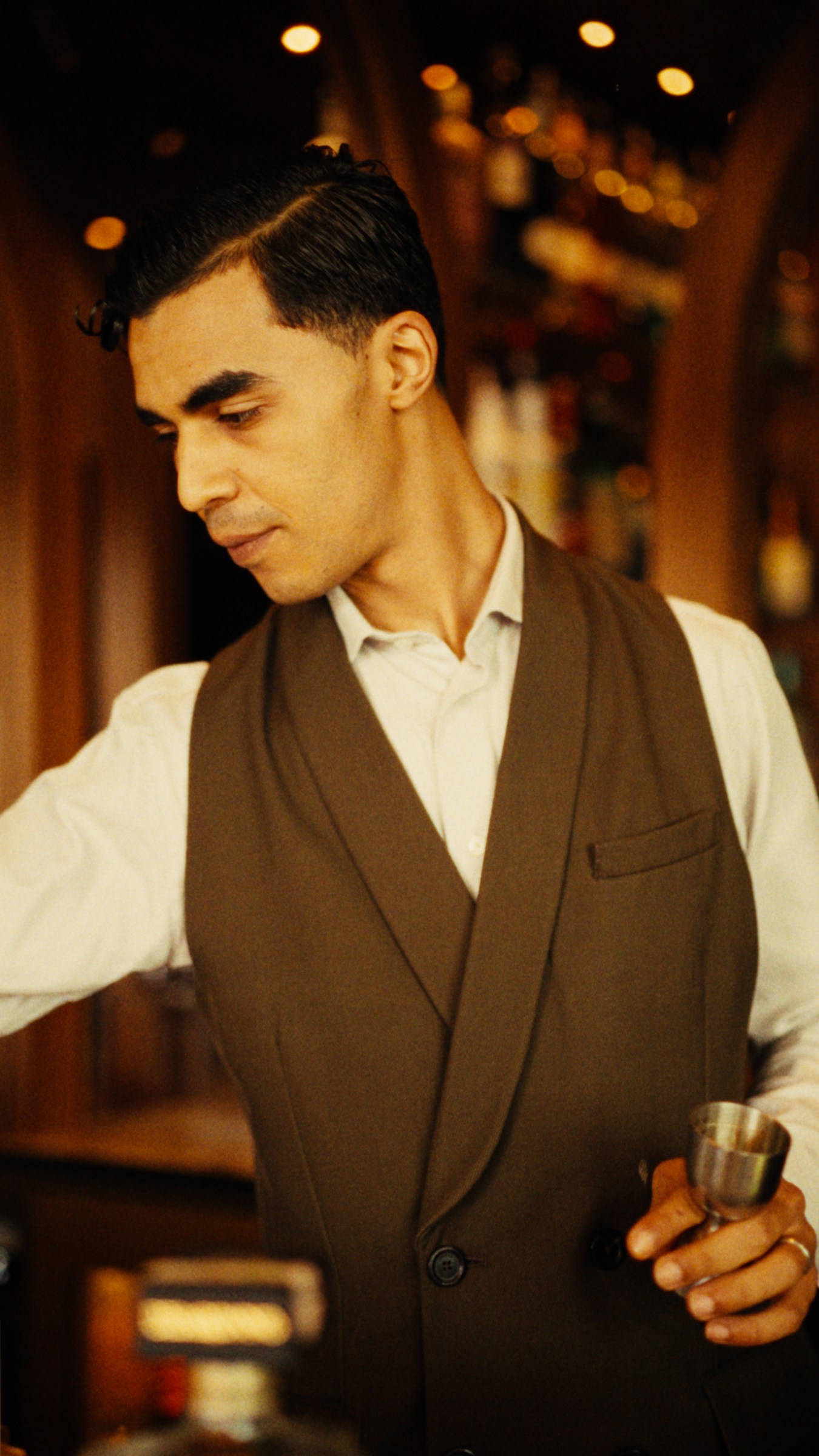 The bartender at work in the warm light of Royal Mansour.