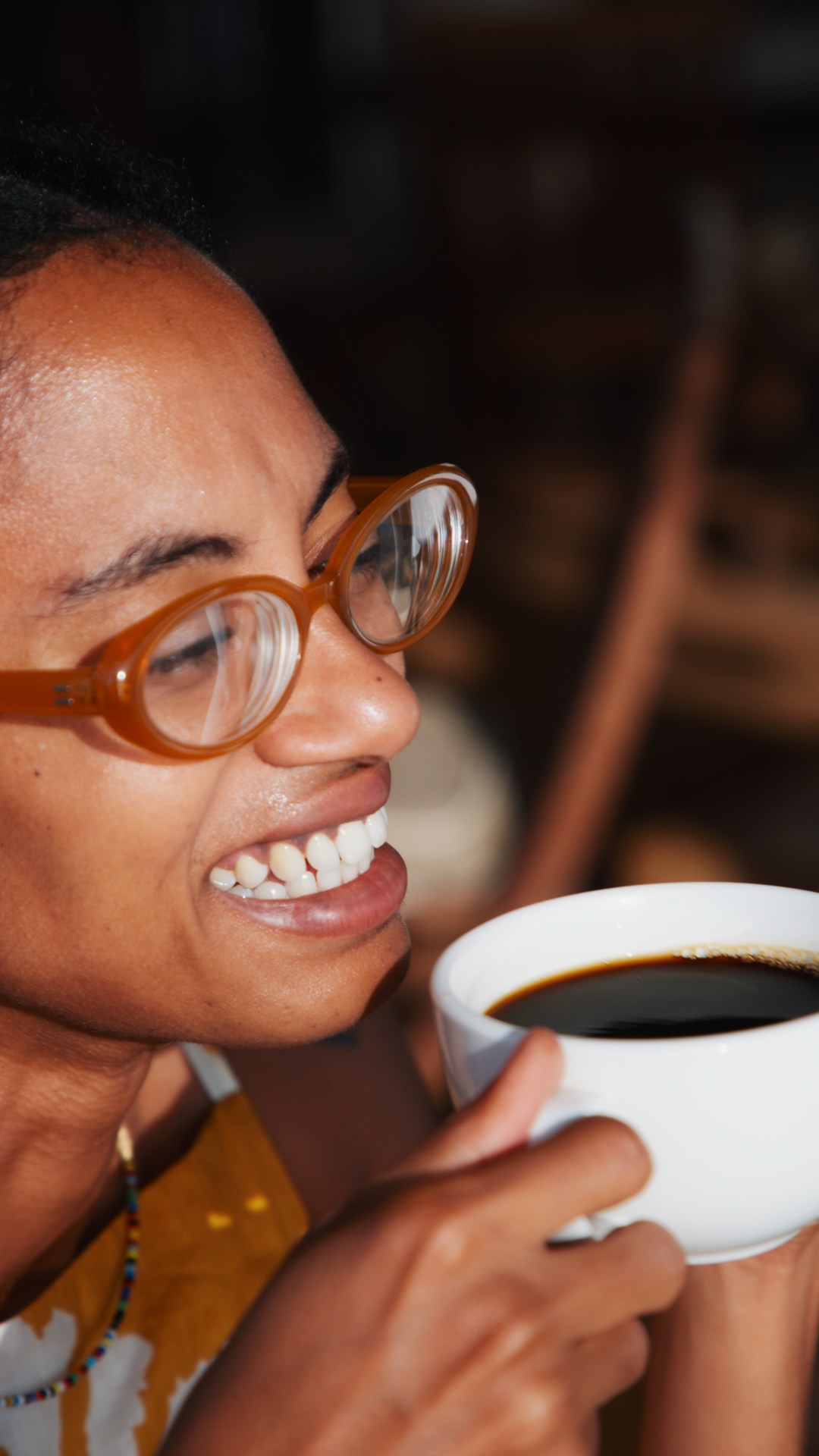 Yaye smiling over her morning coffee at Peponi