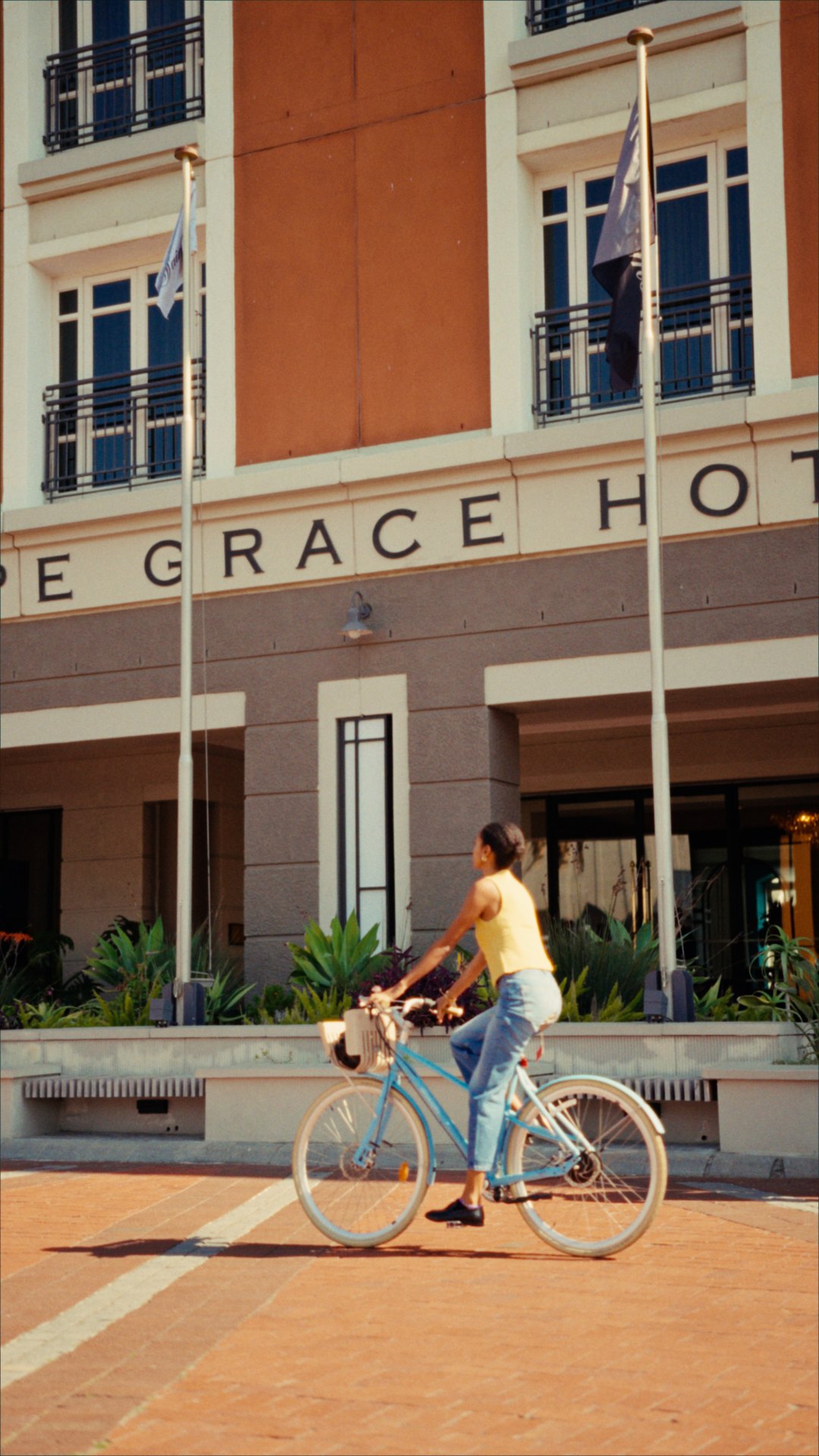 Yaye cycling past the Cape Grace entrance