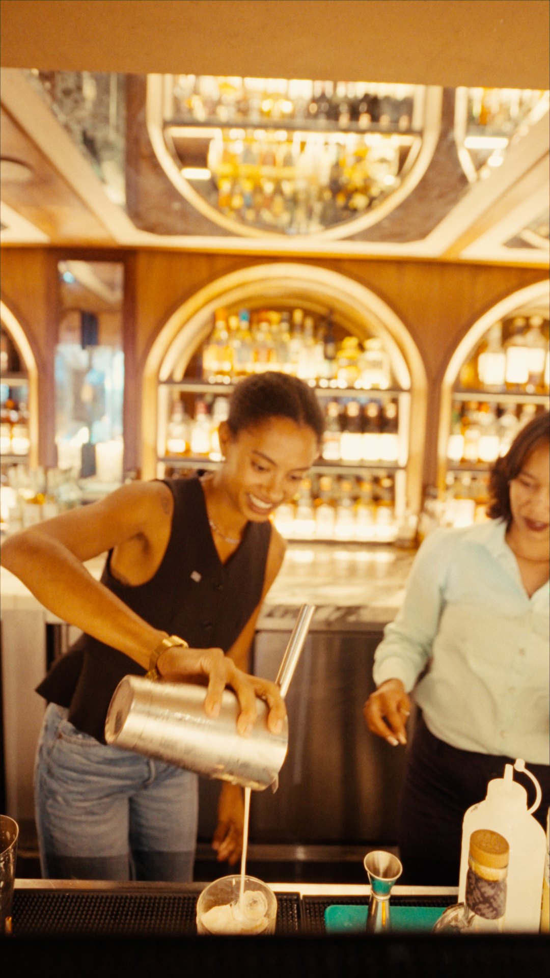 Yaye pouring a cocktail beside the Bascule bartender