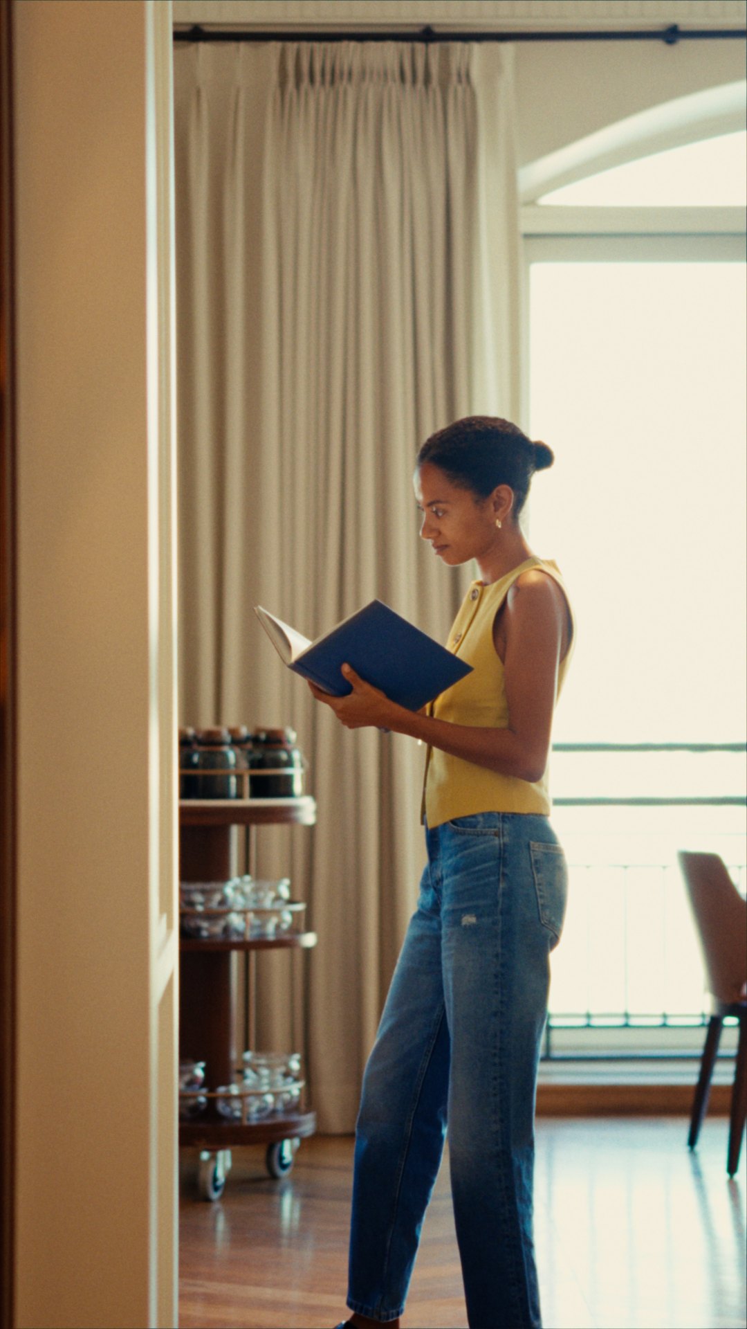 Yaye reading by the window at Cape Grace